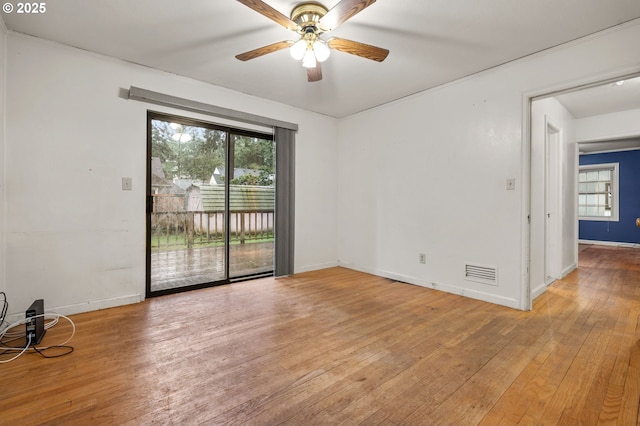 unfurnished room with visible vents, plenty of natural light, ceiling fan, and light wood finished floors