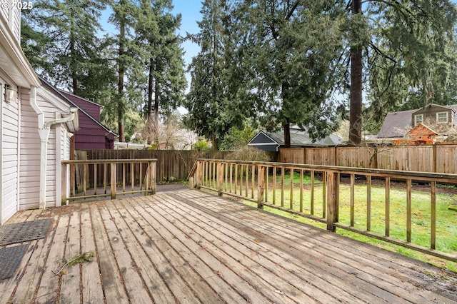 deck with a yard and a fenced backyard