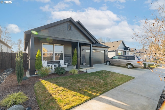 view of front facade featuring a garage, covered porch, and a front lawn