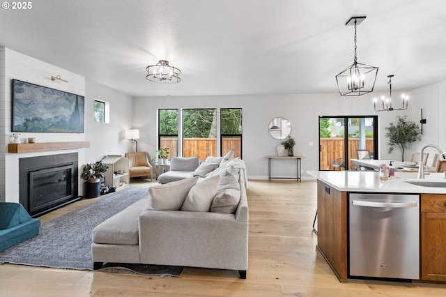 507 Honeysuckle Ln, Eugene, OR 97401 - living room featuring a chandelier, light wood-type flooring, and a large fireplace