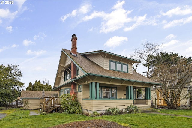 view of front of property with a front yard, crawl space, roof with shingles, and a chimney