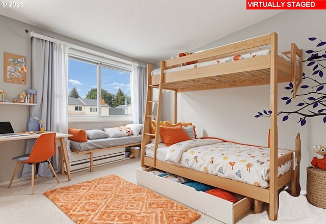 carpeted bedroom with baseboard heating and a textured ceiling