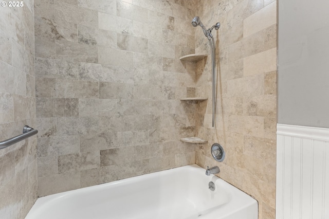 bathroom with shower / bathing tub combination and wainscoting
