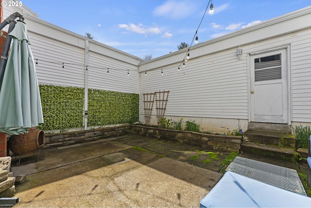 rear view of property featuring entry steps and a patio