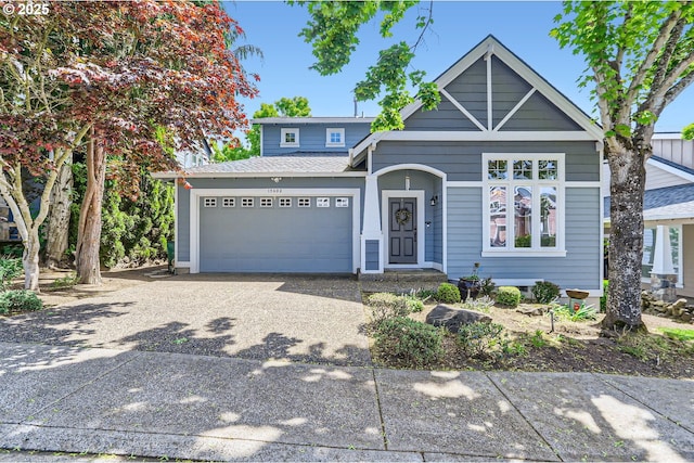 view of front of house with a garage, driveway, and a shingled roof