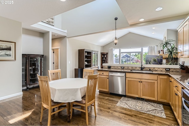 kitchen with dishwasher, a peninsula, a sink, vaulted ceiling, and dark wood-type flooring