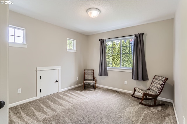 living area with plenty of natural light, carpet flooring, and baseboards
