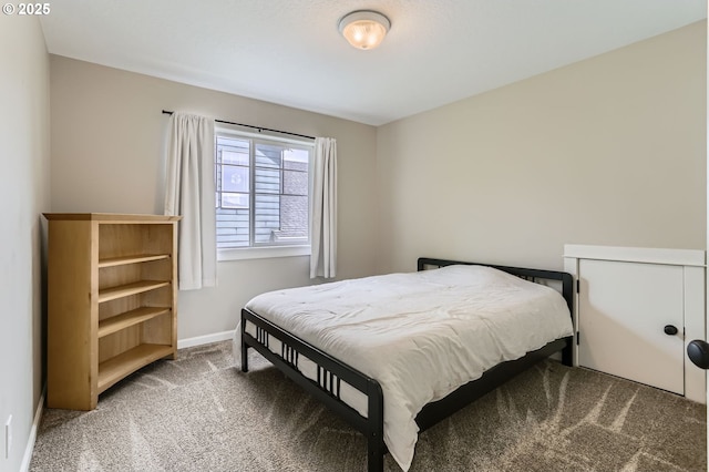 carpeted bedroom featuring baseboards