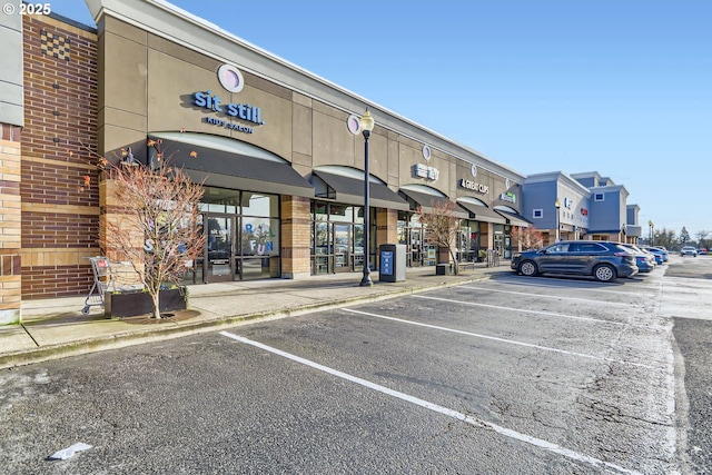 view of commercial property featuring uncovered parking