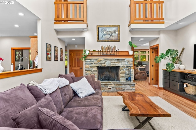 770 N Moss St, Lowell, OR 97452 - living area featuring wood finished floors, a high ceiling, recessed lighting, and a fireplace