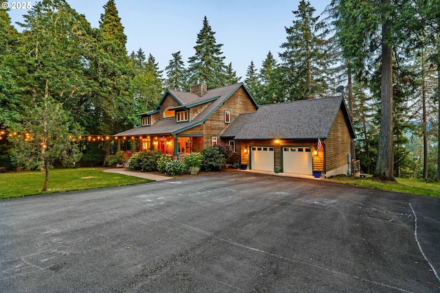 770 N Moss St, Lowell, OR 97452 - view of front facade with a garage, asphalt driveway, a front lawn, and a chimney