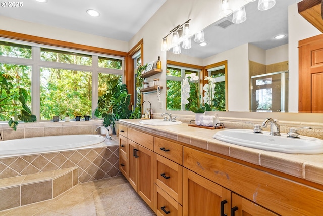 770 N Moss St, Lowell, OR 97452 - full bathroom with tile patterned floors, double vanity, a shower stall, a garden tub, and recessed lighting