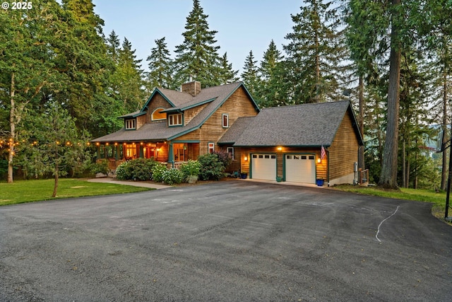 770 N Moss St, Lowell, OR 97452 - view of front of home with a garage, driveway, a chimney, roof with shingles, and a front yard