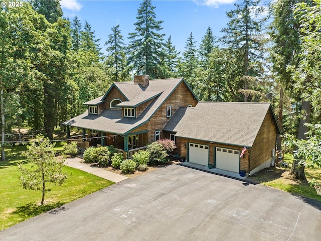 770 N Moss St, Lowell, OR 97452 - shingle-style home with covered porch, an attached garage, a chimney, driveway, and roof with shingles