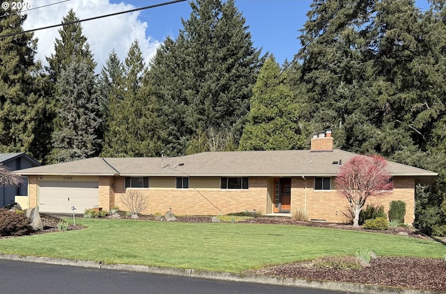 ranch-style home featuring brick siding, a front lawn, a chimney, driveway, and an attached garage