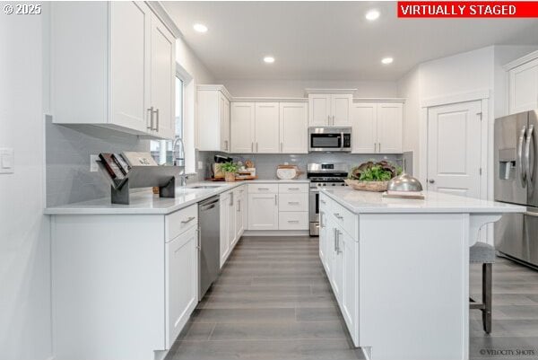 2747 Woodfern Ter Lot 57, Eugene, OR 97403 - kitchen featuring stainless steel appliances, a breakfast bar, a center island, white cabinets, and recessed lighting