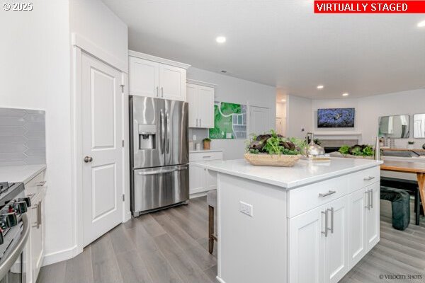 2747 Woodfern Ter Lot 57, Eugene, OR 97403 - kitchen featuring appliances with stainless steel finishes, white cabinetry, light countertops, light wood-style floors, and recessed lighting