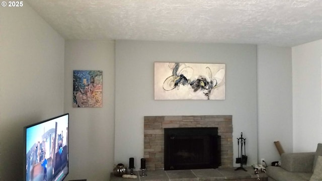 living area featuring a textured ceiling and a fireplace