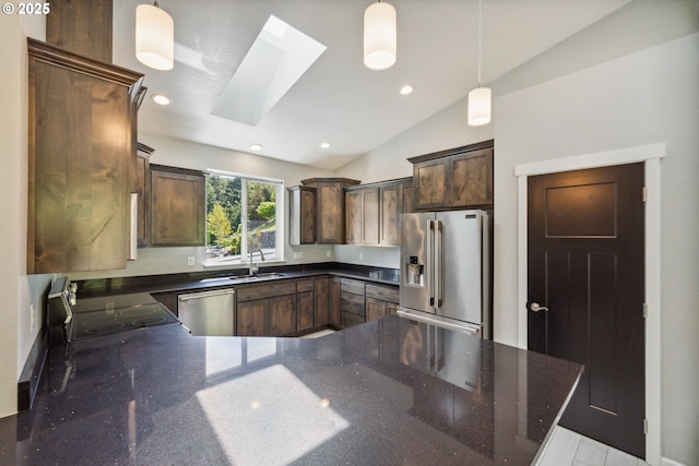 kitchen with stainless steel appliances, lofted ceiling, a peninsula, a sink, and dark brown cabinets