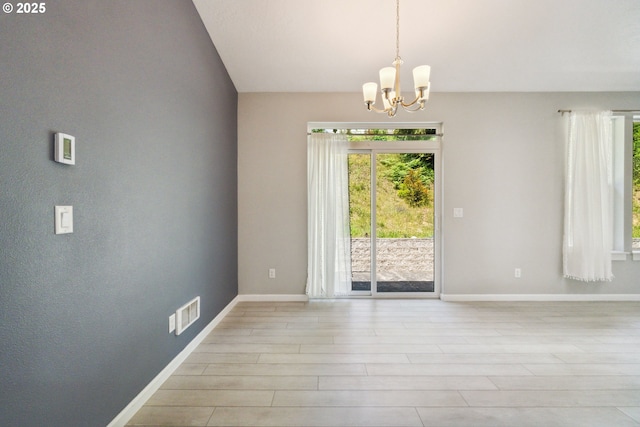 unfurnished dining area with a chandelier, baseboards, and light wood finished floors