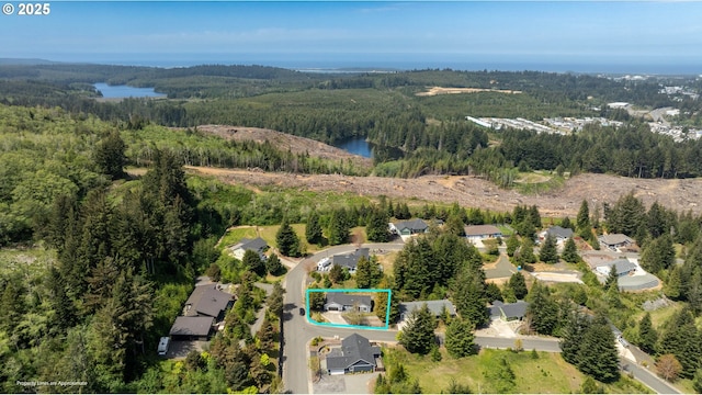 aerial overview of property's location featuring a heavily wooded area and property parcel outlined
