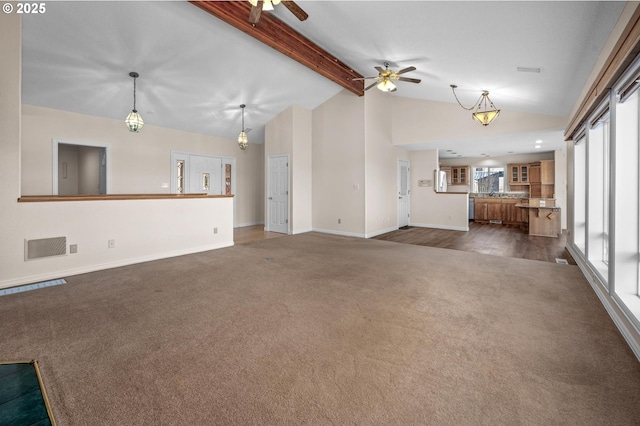 unfurnished living room featuring beamed ceiling, visible vents, a ceiling fan, dark colored carpet, and baseboards