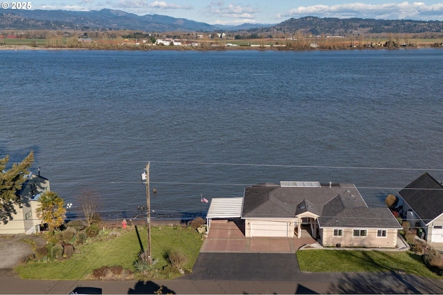 exterior space featuring a water and mountain view