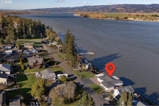 drone / aerial view featuring a water view and a residential view