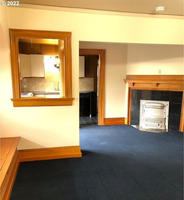 unfurnished living room featuring a tiled fireplace and carpet