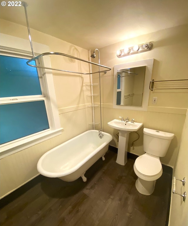 bathroom with sink, wood-type flooring, a tub, and toilet