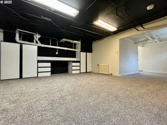 basement with carpet floors and radiator heating unit