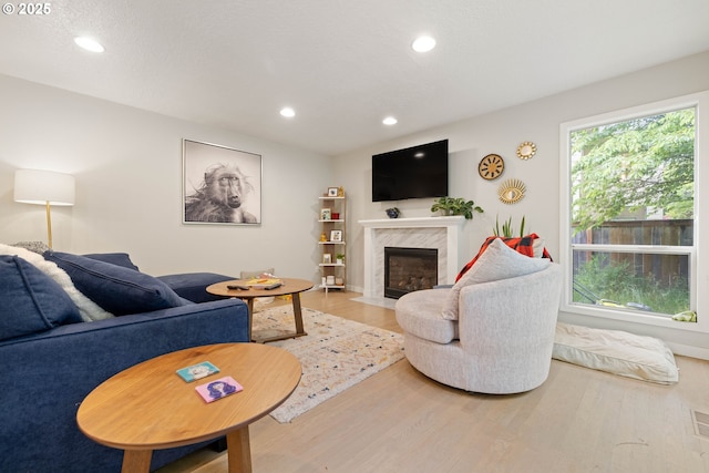 8326 SW 64th Ave, Portland, OR 97219 - living room with wood finished floors, a premium fireplace, recessed lighting, and baseboards