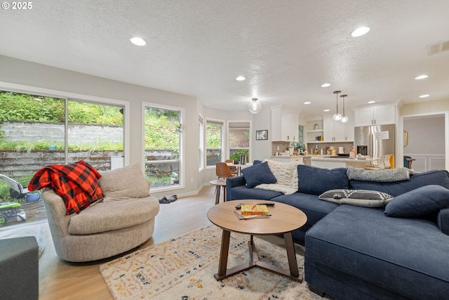 8326 SW 64th Ave, Portland, OR 97219 - living area with light wood-style flooring, recessed lighting, and a textured ceiling