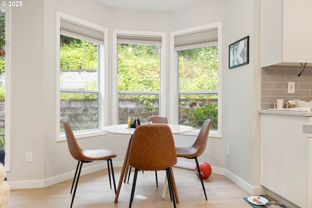 8326 SW 64th Ave, Portland, OR 97219 - dining room with healthy amount of natural light, light wood-style floors, and baseboards