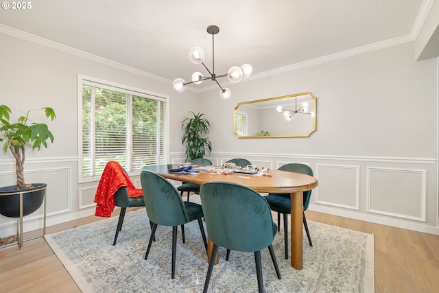 8326 SW 64th Ave, Portland, OR 97219 - dining space featuring a chandelier, crown molding, light wood-style flooring, and a wainscoted wall