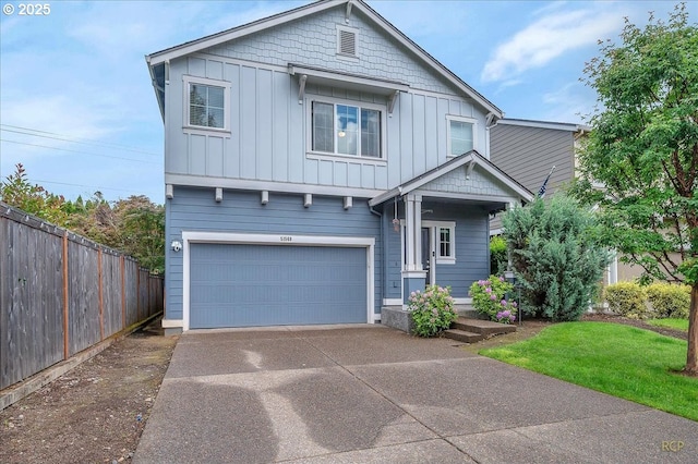 51568 SW S Fork Loop, Scappoose, OR 97056 - view of front of house with board and batten siding, a garage, and concrete driveway