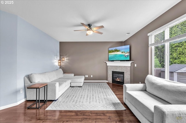 51568 SW S Fork Loop, Scappoose, OR 97056 - living room with ceiling fan, wood finished floors, a tile fireplace, and baseboards
