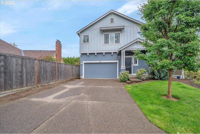 51568 SW S Fork Loop, Scappoose, OR 97056 - view of front facade with board and batten siding, an attached garage, and concrete driveway