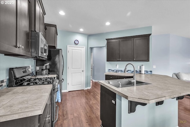 51568 SW S Fork Loop, Scappoose, OR 97056 - kitchen with appliances with stainless steel finishes, a sink, dark wood-style floors, light countertops, and dark brown cabinetry