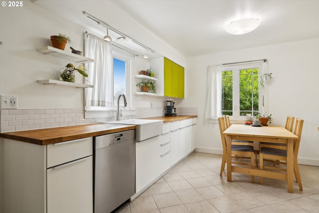 kitchen with open shelves, butcher block countertops, dishwasher, tasteful backsplash, and rail lighting