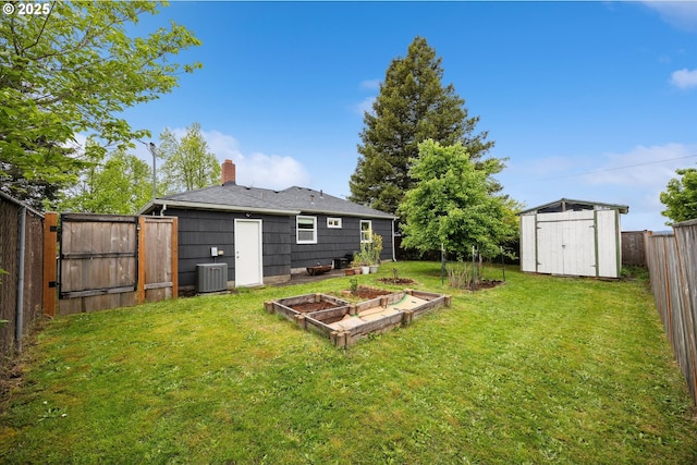 view of yard featuring central air condition unit, a shed, a vegetable garden, and an outdoor structure