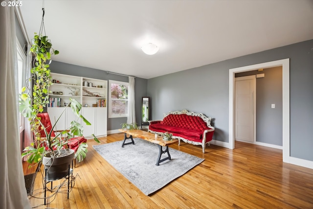 sitting room with wood finished floors and baseboards