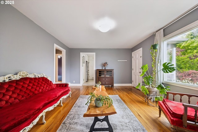 living area with wood finished floors and baseboards