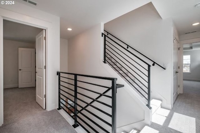 staircase featuring carpet floors, visible vents, and recessed lighting