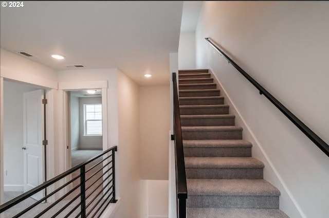 staircase with baseboards, visible vents, and recessed lighting