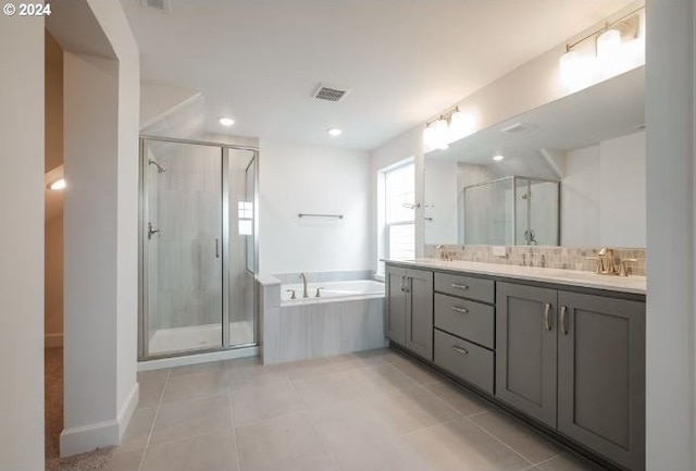 full bathroom featuring double vanity, a sink, a stall shower, and a bath