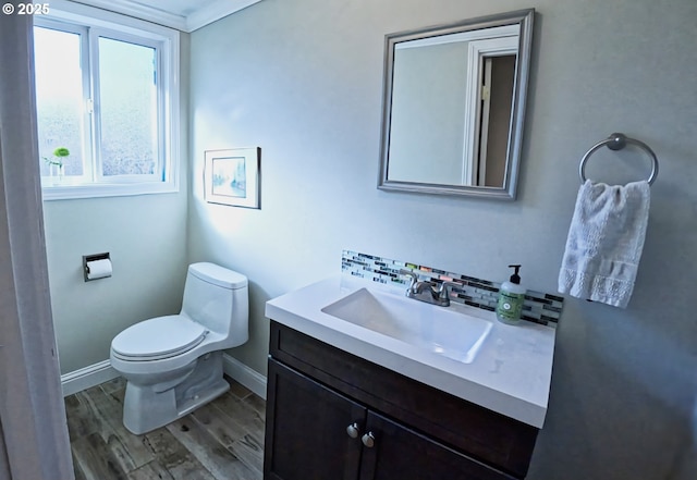 bathroom featuring hardwood / wood-style flooring, decorative backsplash, vanity, and toilet