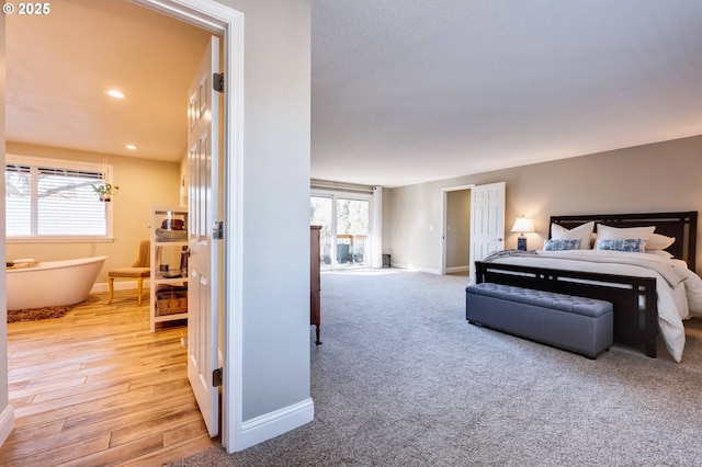 bedroom with light hardwood / wood-style floors and multiple windows