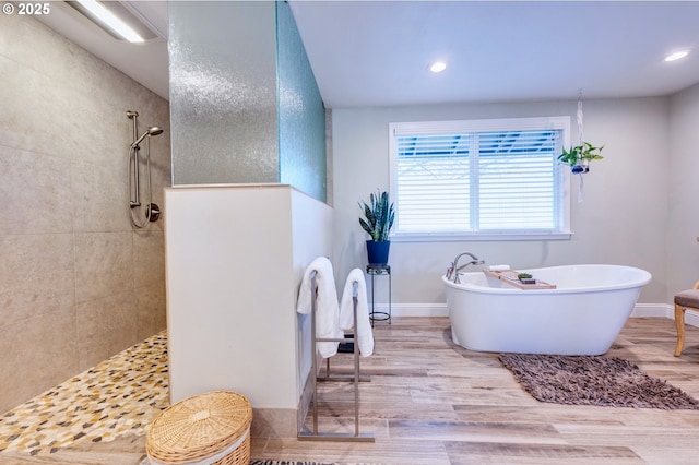 bathroom with hardwood / wood-style floors and separate shower and tub