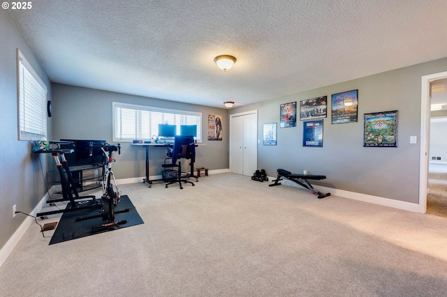 workout room with carpet floors and a textured ceiling